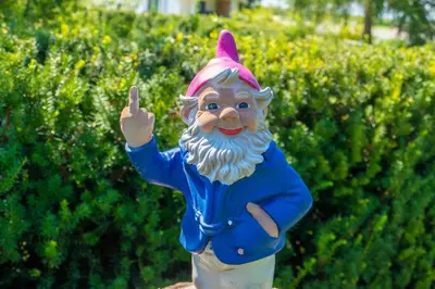 a statue of a man with his index finger up at Modrin Apartments in Kamnik