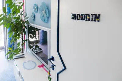 a door that says momma next to a plant at Modrin Apartments in Kamnik