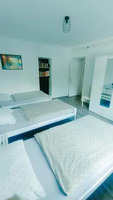a room with three beds in a room at Naturalina in Tolmin