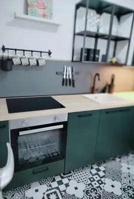 a kitchen with green cabinets and a sink and a stove at Naturalina in Tolmin