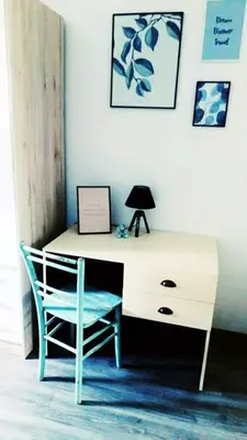a desk with a chair and a lamp in a room at Naturalina in Tolmin