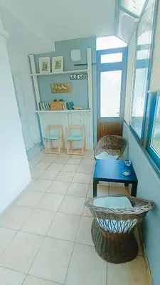a room with a blue table and two chairs at Naturalina in Tolmin