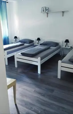 three beds sitting in a room with at Naturalina in Tolmin