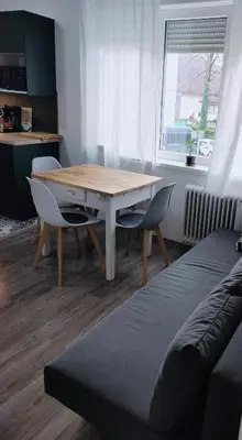 a table and chairs in a room with a window at Naturalina in Tolmin