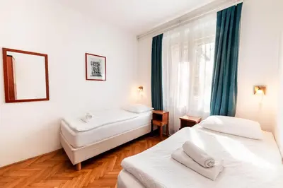 a hotel room with two beds and a window at Penzion Pod Lipo in Ljubljana