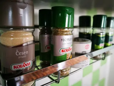 a shelf with jars of spices on it at Boomerang Apartment Bled in Bled