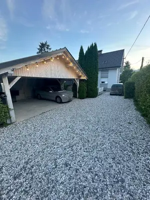 a garage with a car parked in a driveway at Boomerang Apartment Bled in Bled