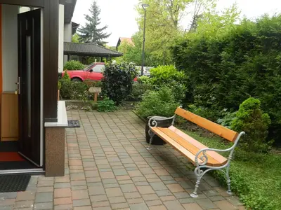 a wooden bench sitting outside of a house at Peter rooms in Ljubljana