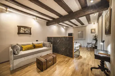 a living room with a couch and a piano at Hotel Pok Garni in Brezovica