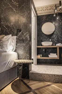 a bedroom with a bed and a bathroom with a tub at Hotel Pok Garni in Brezovica