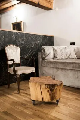 a living room with a couch and a table and a chair at Hotel Pok Garni in Brezovica