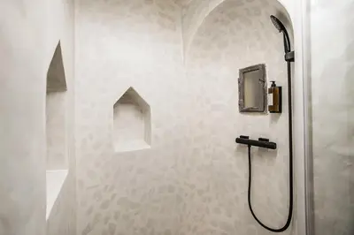a shower stall in a bathroom with a shower at Hotel Pok Garni in Brezovica