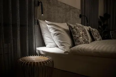a white couch with pillows in a room at Hotel Pok Garni in Brezovica