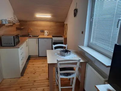 a small kitchen with a table and two chairs at Apartments Vidic in Bled