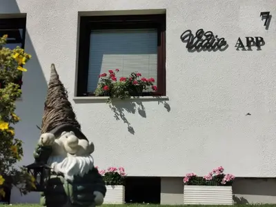 a building with a window and a statue in front of it at Apartments Vidic in Bled
