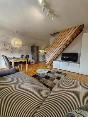 a living room with a couch and a table at Apartment Amazing View in Bohinj