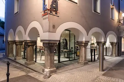 a building with arches on the side of it at Hostel Situla in Novo Mesto