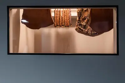 a framed picture of a pair of earrings and a necklace at Hostel Situla in Novo Mesto