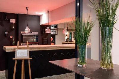 a kitchen with two vases with plants on a table at Hostel Situla in Novo Mesto