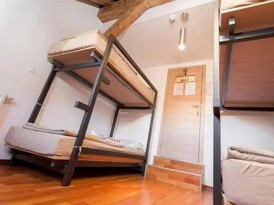 a bunk bed room with two bunk beds in it at Hostel Situla in Novo Mesto