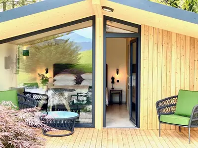 a sliding glass door on a patio with a table and chairs at Apartments Pri nas in Kobarid