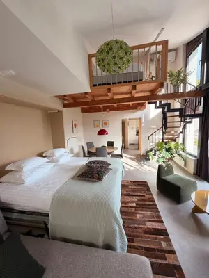 a large bedroom with two beds and a balcony at Apartments Pri nas in Kobarid