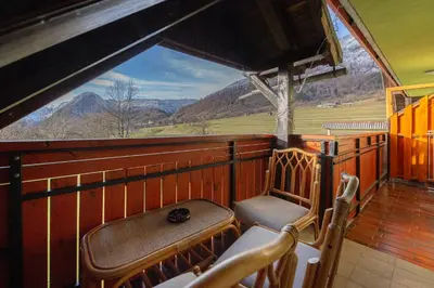 a balcony of a train with a view of the mountains at Apartmaji Hodak in Bohinj