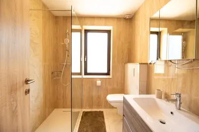 a bathroom with a toilet and a sink and a shower at Apartment Tiara 2 in Rodine