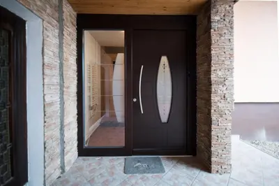a black door with a surfboard sticking out of it at Apartment Tiara 2 in Rodine