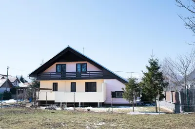 a house with a black and white at Apartment Tiara 2 in Rodine