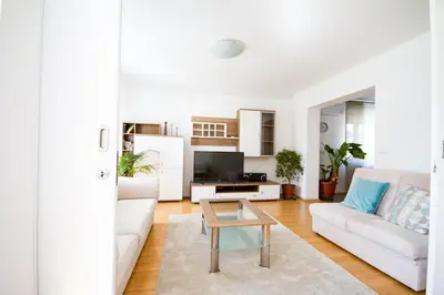a living room with a white couch and a table at Apartma in Ormoz