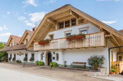 a building with a balcony with flowers on it at Garni Hotel Berc in Bled