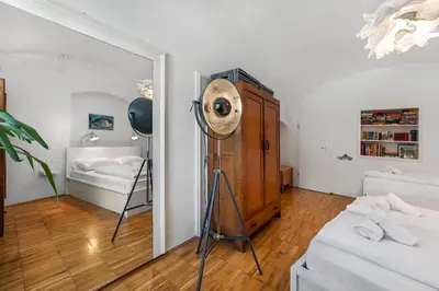 a room with a fan and a mirror at ROG Apartment with Furnished Courtyard in Ljubljana