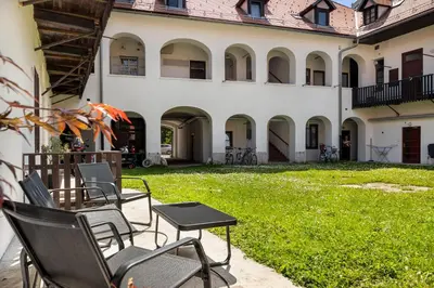 a group of chairs and tables in front of a building at ROG Apartment with Furnished Courtyard in Ljubljana