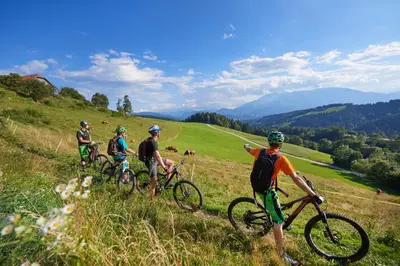 a group of people riding bikes on a hill at BikeSki family hotel, b&b, apartaments, rooms in Mežica
