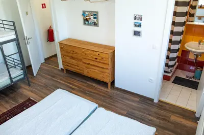 a bathroom with a sink and a wooden dresser at BikeSki family hotel, b&b, apartaments, rooms in Mežica
