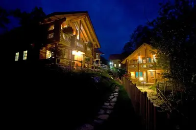 a night view of a house with lights on at Kamp Koren Kobarid in Kobarid
