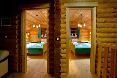 a room with two beds in a log cabin at Kamp Koren Kobarid in Kobarid