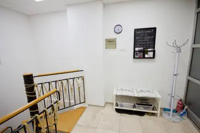 a room with a staircase and a clock on the wall at Blue Point Apartment Ljubljana in Ljubljana