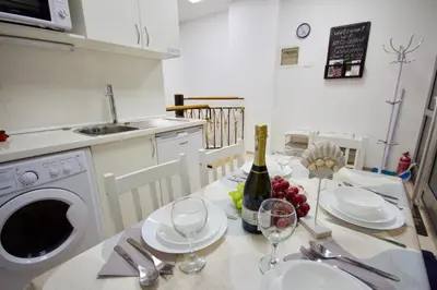 a kitchen with a table with a bottle of wine at Blue Point Apartment Ljubljana in Ljubljana