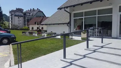 a black railing in front of a house at klass 203 in Kranjska Gora