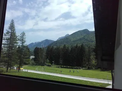 a view from a window of a park with mountains at klass 203 in Kranjska Gora
