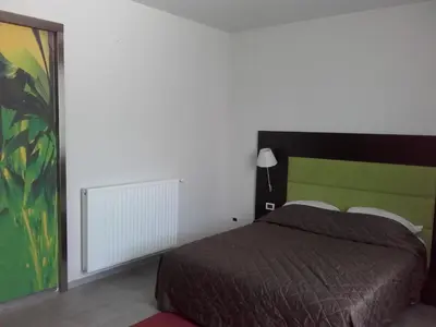 a bedroom with a bed and a green headboard at klass 203 in Kranjska Gora