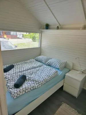a large bed in a room with a window at Cozy Cabin in Čatež ob Savi