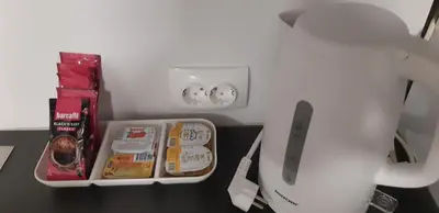 a white refrigerator with some food and drinks on a table at Cozy Cabin in Čatež ob Savi