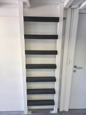 a staircase in a building with black and white stripes at Cozy Cabin in Čatež ob Savi