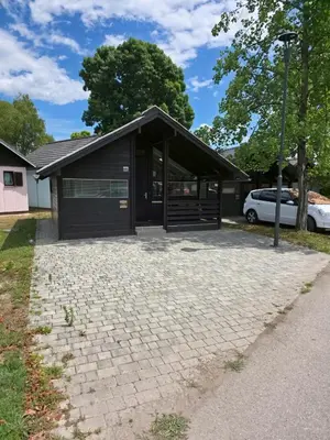 a house with a garage with a driveway at Cozy Cabin in Čatež ob Savi