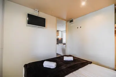 a bedroom with a bed with two towels on it at Lake View Mobile Homes with Thermal Riviera Tickets in Terme Čatež in Čatež ob Savi