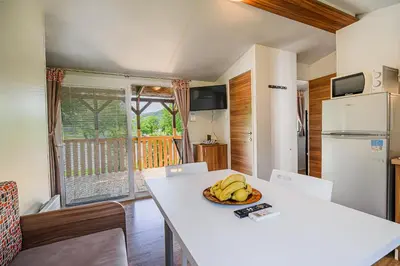 a kitchen with a table with a bowl of bananas on it at Lake View Mobile Homes with Thermal Riviera Tickets in Terme Čatež in Čatež ob Savi