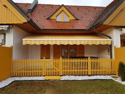 a yellow fence in front of a house at TULPIKA 13 in Moravske Toplice